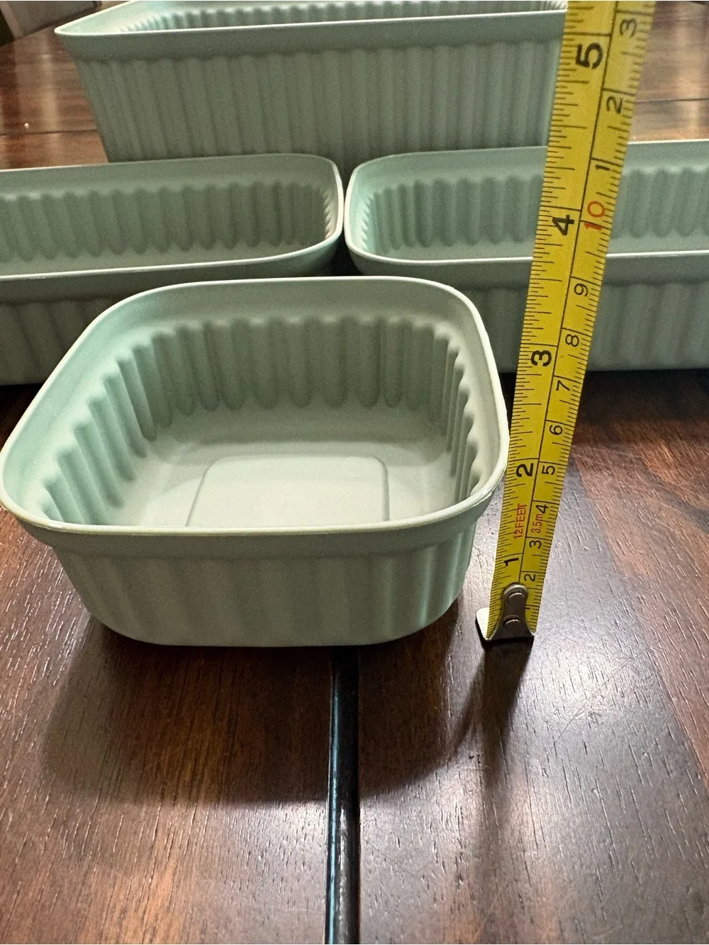 Set of 7 sage green plastic storage containers
